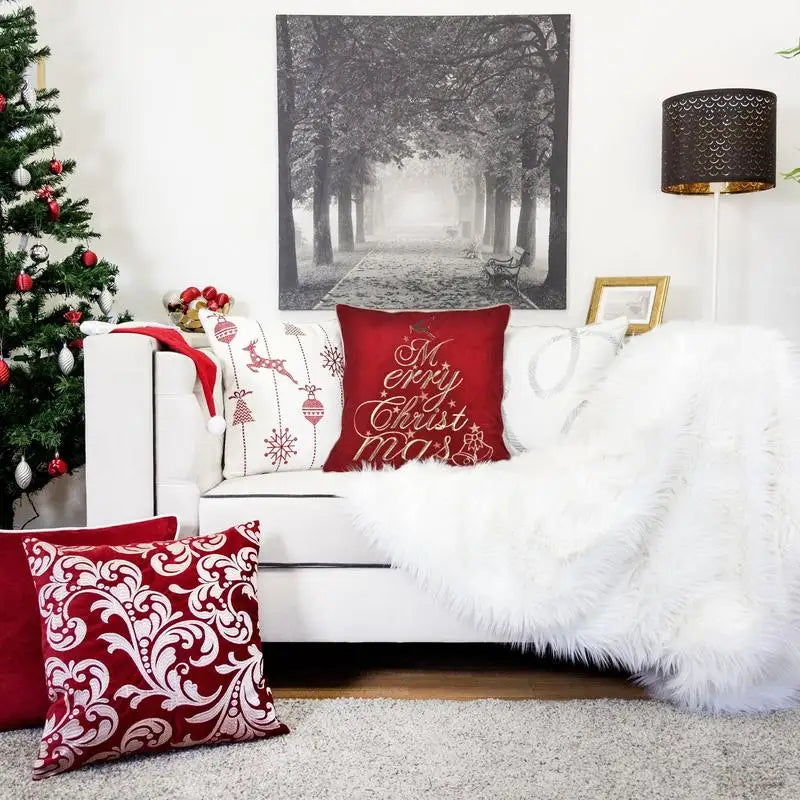 Stylish red velvet throw pillow in a holiday setting, featuring shimmering Merry Christmas embroidery for a cheerful touch.