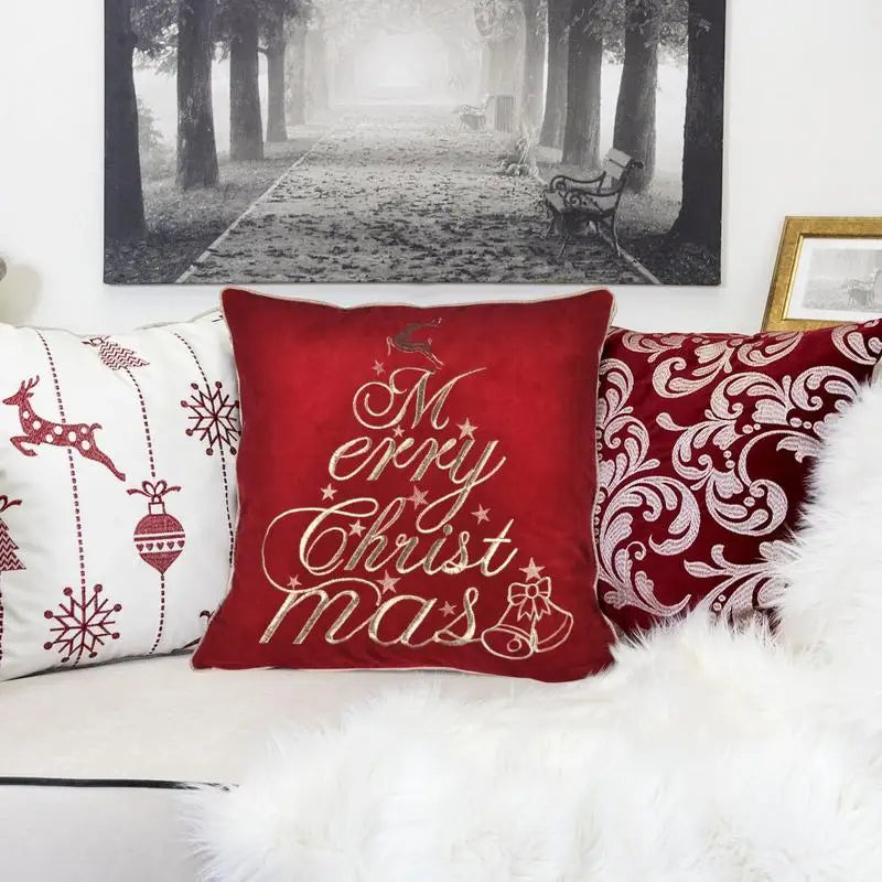 Close-up of Red Velvet Throw Pillow showcasing the elegant "Merry Christmas" stitching, ideal for holiday decorations.